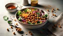 Photorealistic image of a vibrant vegan BBQ chickpea salad in a modern bowl on a simple table, featuring roasted chickpeas, mixed greens, and light dressing.