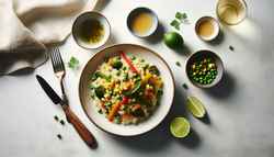 Minimalist table setting with a vegan Asian-inspired risotto, featuring stir-fried vegetables and lime wedges, with a clutter-free background.