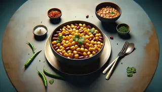 Vibrant maize flour and bean stew garnished with fresh cilantro on a minimalist table setting, showcasing African-inspired vegan side dish