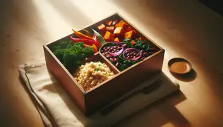 African-inspired vegan bento box on a wooden table, with sorghum, roasted sweet potatoes, sautéed kale, red onions, and black beans in natural light.