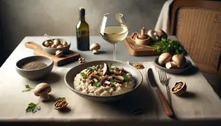 Creamy vegan mushroom and walnut risotto with truffle oil, garnished with parsley on a minimalist table, next to vegan white wine, against a neutral backdrop.