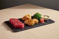 The Neo-Umi Ocean Harvest Platter Minimalist vegan seafood: ruby watermelon sashimi, seared mushroom scallops, and hearts of palm on dark slate. Elegant Japanese plant-based art.