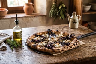 Artisan vegan pizza with charred radicchio and walnut cream on a rustic wooden table with soft natural lighting.