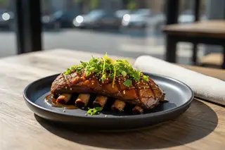 Smoked king oyster ribs with miso-bourbon glaze, yuzu zest & herbs on charcoal ceramic. Sunny California-meets-Tokyo BBQ aesthetic.