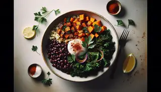 Colorful African-inspired vegan breakfast bowl featuring millet, maple-glazed sweet potatoes, sautéed kale with red onions, black beans, parsley, and lemon drizzle.