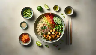 Minimalist dining table featuring a Vegan Asian Fusion Bowl with brown rice, tofu, vegetables, sesame seeds, and cilantro, accented with lime wedges.