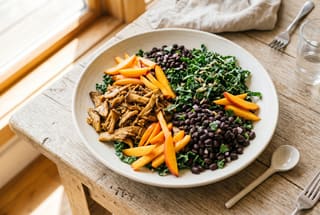 Sun-Drenched Pulled Mushroom and Stone Fruit Shredded Buffet A colorful vegan shredded salad with pulled mushrooms, julienned peaches, and kale on a white platter in natural sunlight.