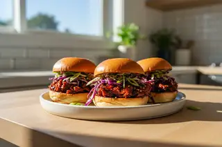 Vibrant vegan Char Siu jackfruit sliders with purple Szechuan slaw and hoisin glaze, a bright Asian-American BBQ fusion dish.
