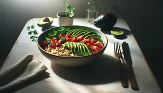 Image of a vegan rice bowl with brown rice, sliced avocado, diced tomatoes, and chopped cilantro, drizzled with lime juice, in a bright, minimalist setting.