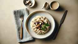 A plate of vegan Mushroom Risotto with a sprig of fresh parsley on a simple, inviting table setting.