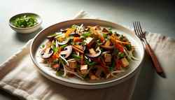Vegan shredded mushroom and tofu stir-fry on a white plate, garnished with cilantro and green onions, in natural light on a minimalist table.