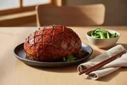 Glossy mahogany Gochujang glazed vegan roast with diamond scoring on a minimalist charcoal platter, garnished with micro-shiso and bok choy.