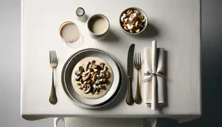 Exquisite Mushroom Medley in luxurious cashew cream sauce on a minimalist table setting, evoking elegance and indulgence.