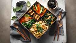 Vegan Bento-Inspired Pasta Box on a minimalist table, featuring handmade pasta, tempeh, vegetables, miso-soy sauce, sesame seeds, and cilantro in natural light.