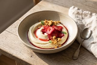 Ruby-red pickled strawberries atop whipped lemon crema with toasted masa crumble in an artisanal ceramic bowl on an oak table.