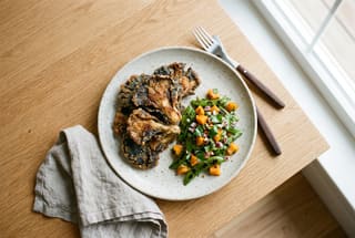 Pan-Seared Blue Masa Mushrooms with Charred Snap Pea and Apricot Salsa Golden-brown masa-crusted mushrooms served with a vibrant green and orange pea and apricot salsa on a rustic plate.